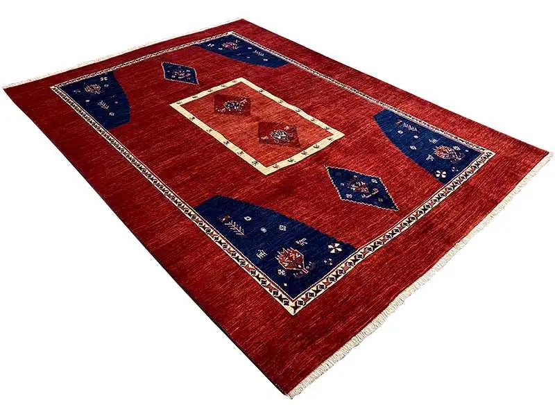 Rug with a red background, blue decorative panels, and a cream-colored border in a diamond design