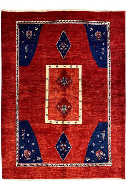 Rug with a red background, a central cream-colored rectangle, and blue diamonds in a framed border