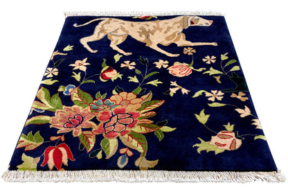 Blue rug with fringes and a large floral and bird pattern