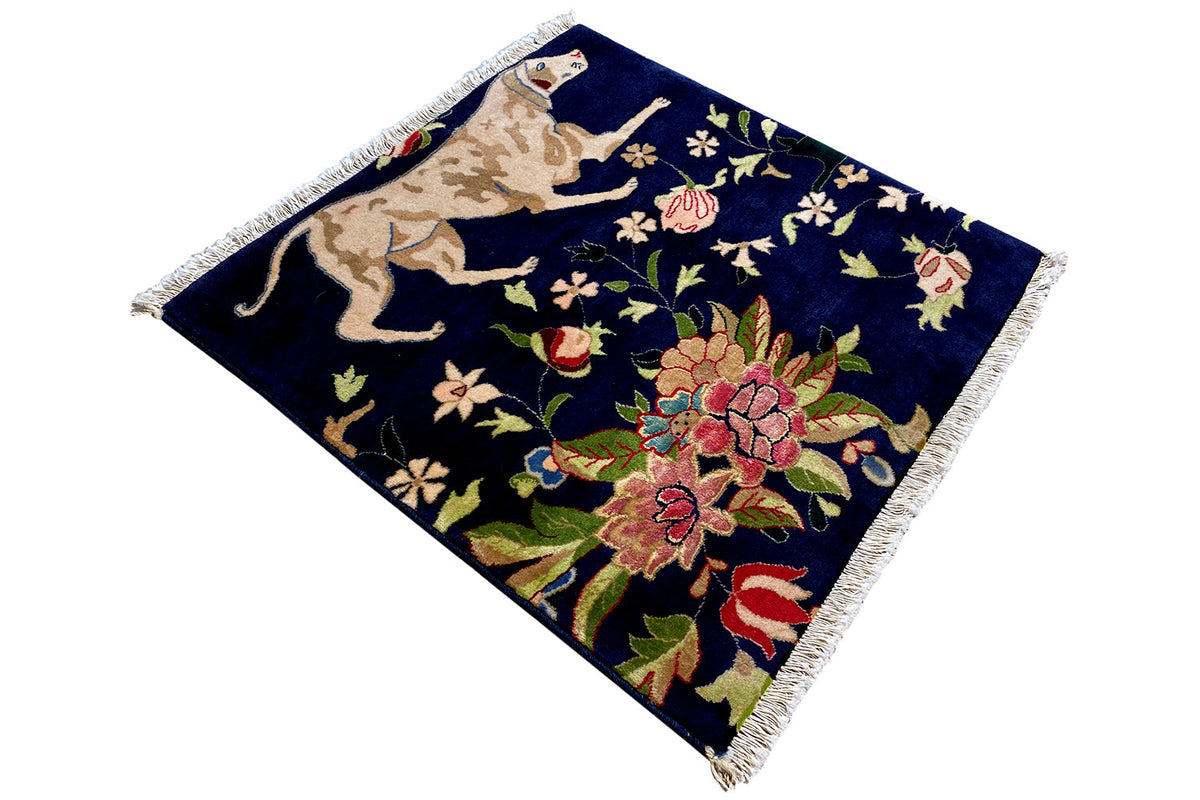 Blue rug with fringes, animal and floral motifs in an Oriental style