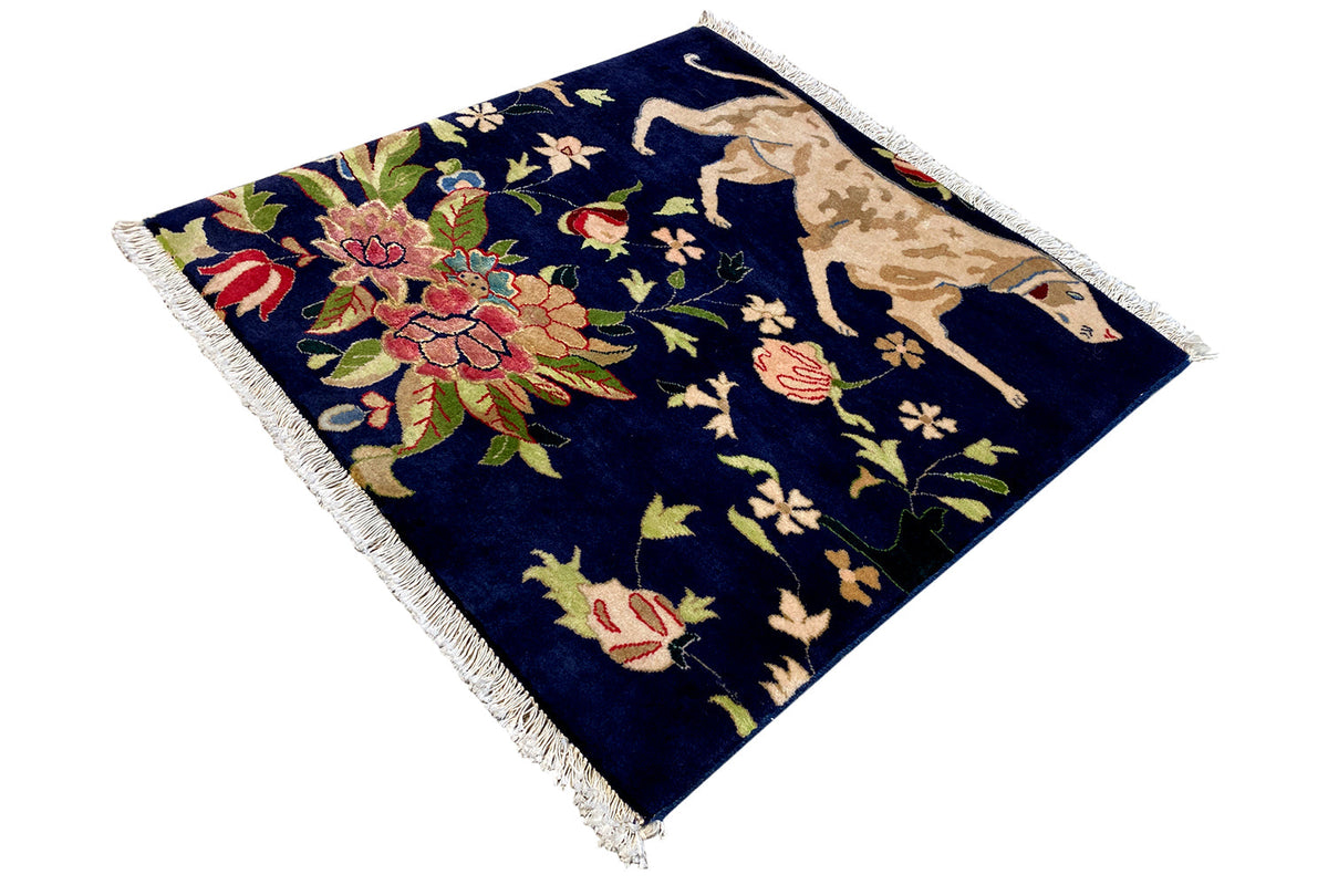 Blue fringed rug with a bouquet of flowers and animal patterns in an oriental style