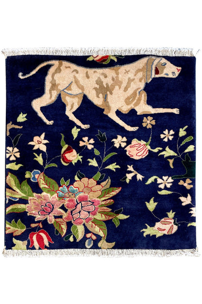 Blue rug with fringes, featuring an oriental animal and floral pattern