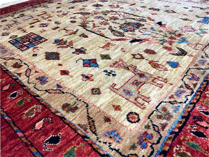 Qashqai exclusive rug, close-up: beige pile with colorful figures and ornaments
