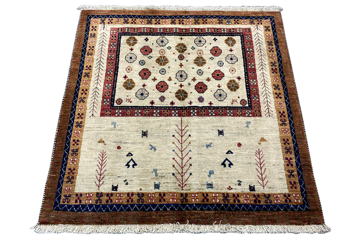 Rectangular rug with a central medallion and border in blue, red, and cream
