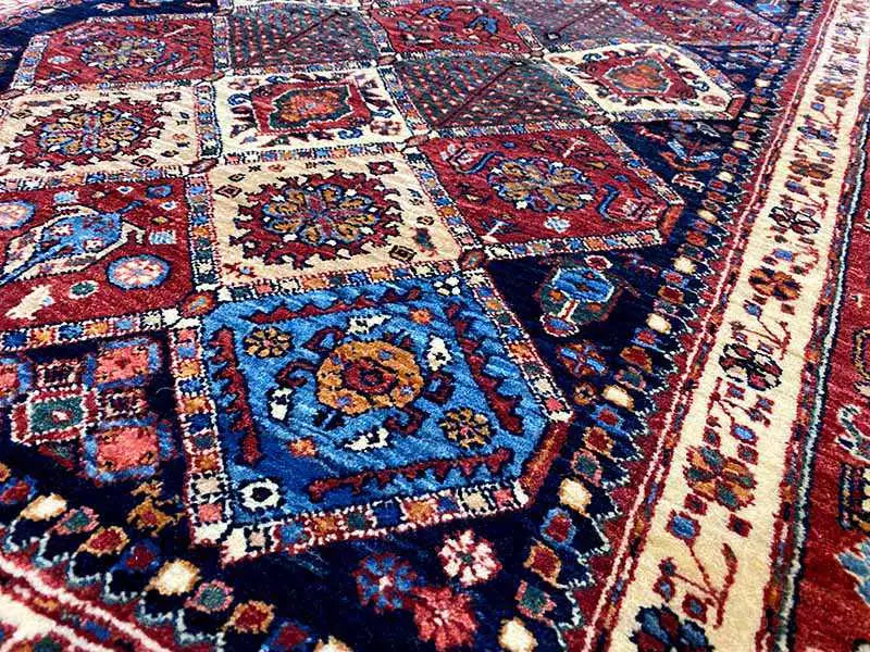 Close-up: Carpet surface with floral ornaments in blue, red, white, and beige