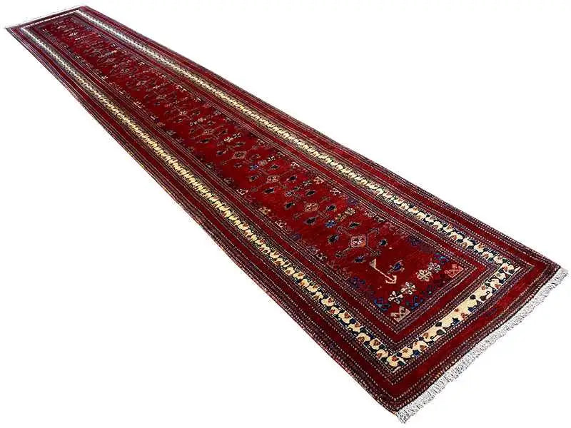 Red runner with narrow decorative borders and a central medallion