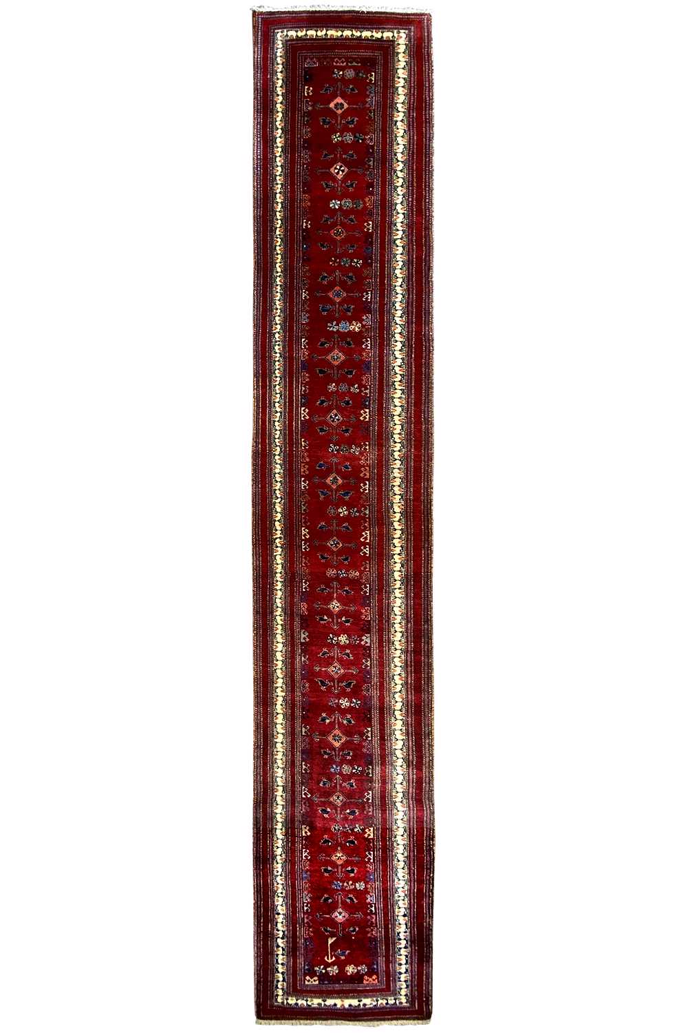 Narrow red runner with a rectangular border and a fine multicolored trim
