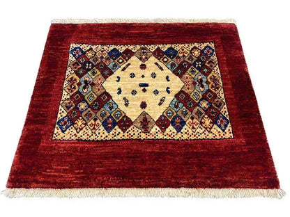 Rug 74x60 cm with a red border, a cream medallion, and colorful ornaments