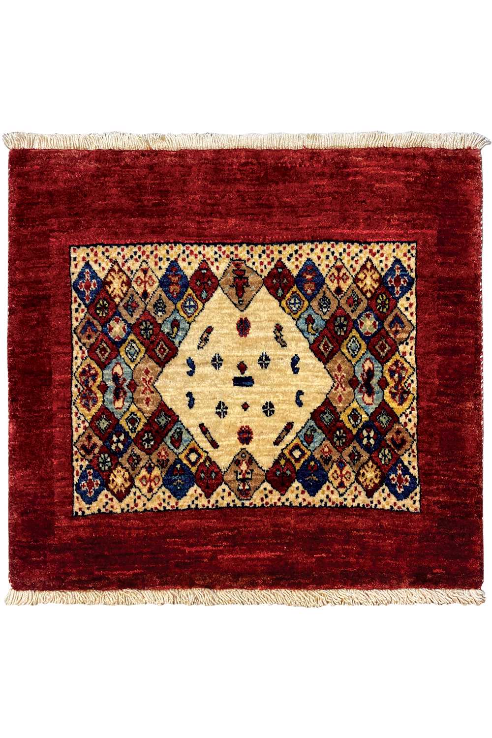 Rug 74x60 cm viewed from above: red border, symmetrical diamond ornaments, and fringes