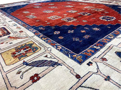 Oriental rug corner with a red central field, dark blue border, and cream-colored medallions