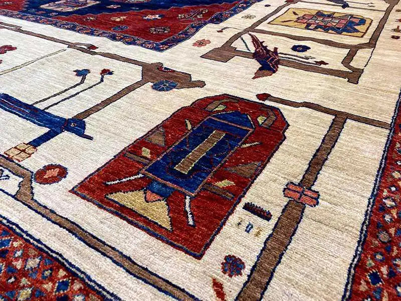 Carpet detail with a red central element on a beige background, surrounded by ornaments