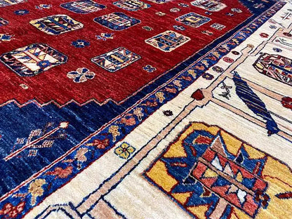 Detail view: red Oriental rug with a blue border and beige ornamental stripe