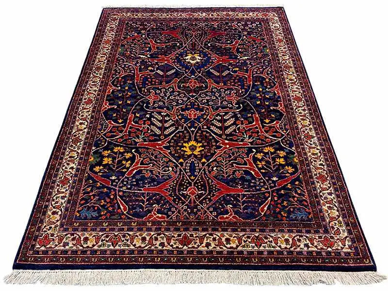 Dark blue Oriental rug with a red ornamental pattern and fringes