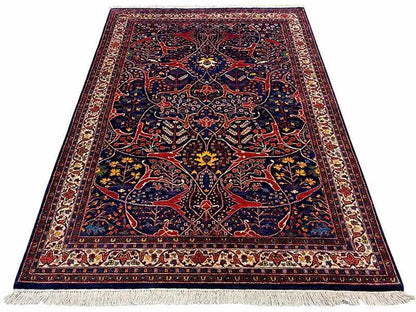 Dark blue Oriental rug with a red ornamental pattern and fringes