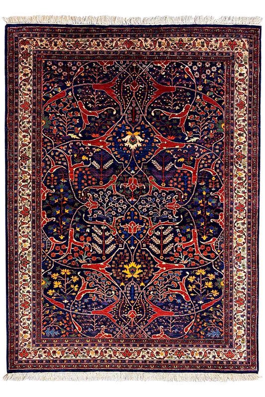 Oriental rug with dark blue and red, central medallion, and fringes