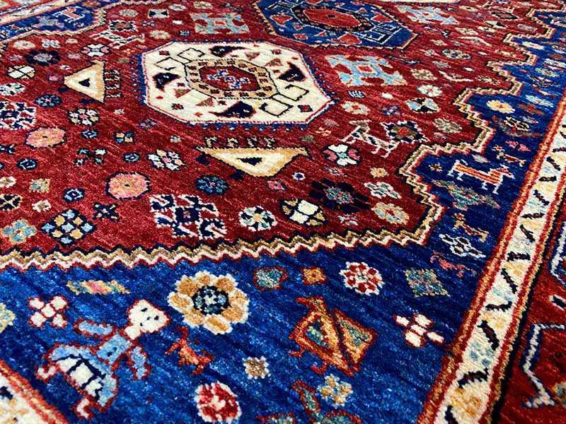 Carpet (144x98 cm) detail with a dense red-and-blue pattern and beige medallions