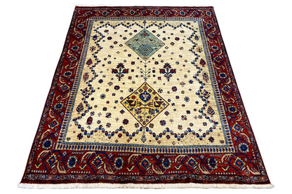 Oriental rug viewed at an angle with a cream-colored background, red border, and central medallion