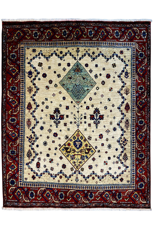 Oriental rug with a cream-colored background, outlined in blue and red, and featuring diamond motifs