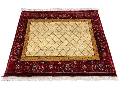 Rug with a red ornamental field and beige rectangular inner area, framed by a yellow border.