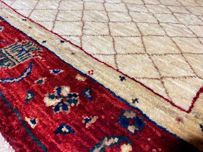 Carpet detail: beige diamond pattern in the inner field and red border