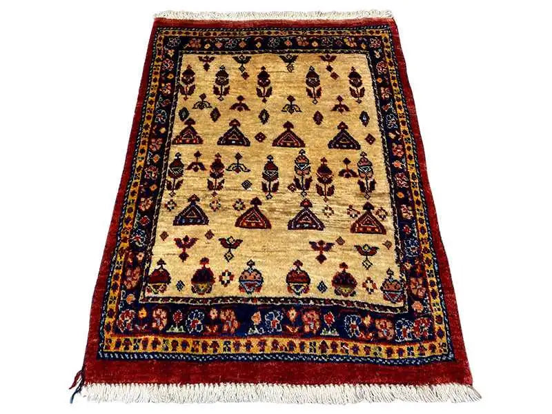 Rug with a beige background, dark border, geometric patterns, and fringe at the bottom