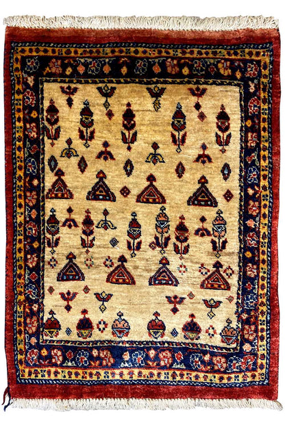 Rug with a beige base, dark border, and colorful embroidered patterns, with fringe along the bottom and sides