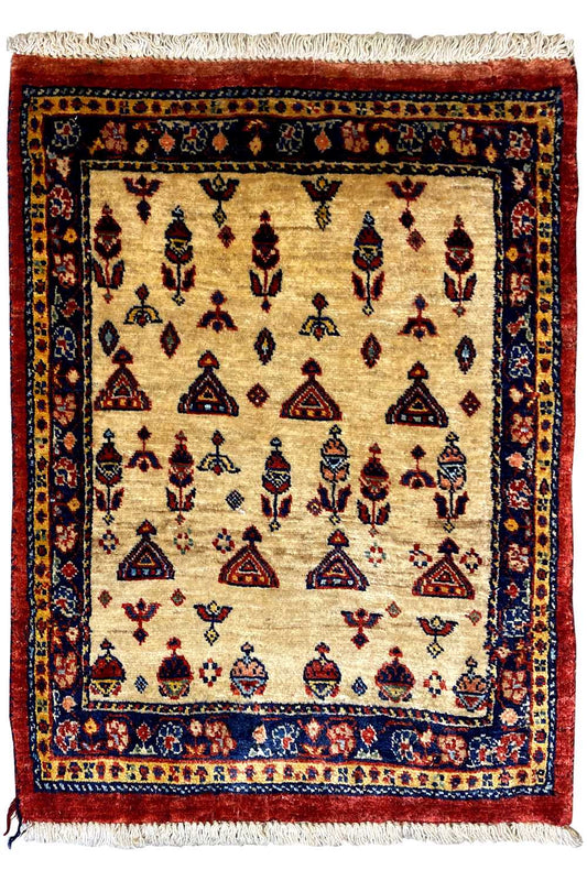Rug with a beige base, dark border, and colorful embroidered patterns, with fringe along the bottom and sides