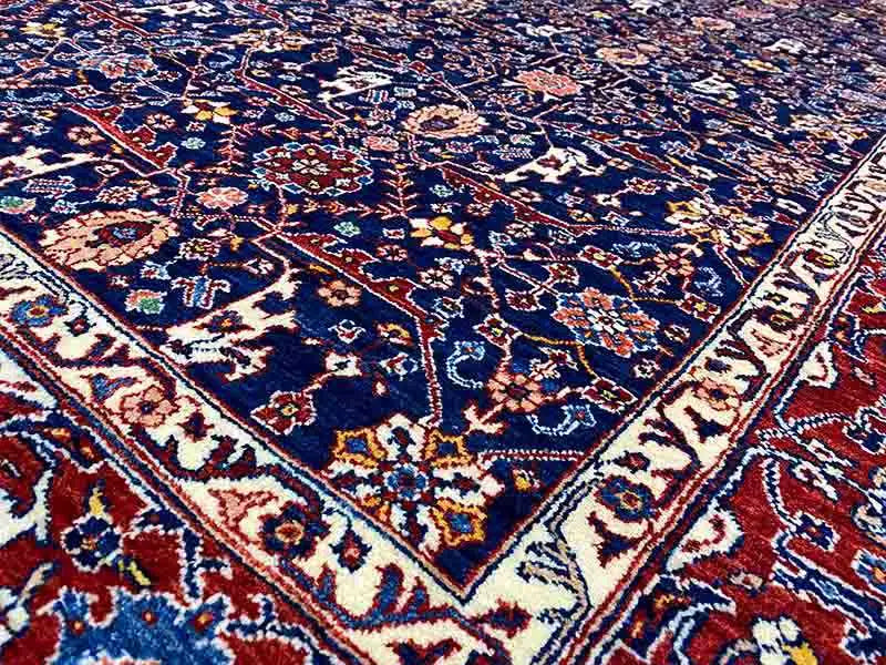 Close-up of exclusive Qashqai Oriental rug: dense blue-red ornamental pattern
