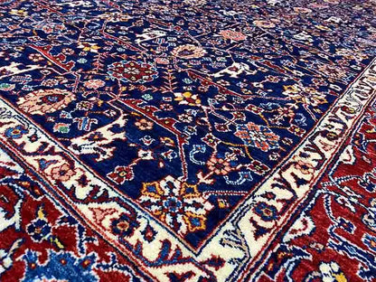 Close-up of exclusive Qashqai Oriental rug: dense blue-red ornamental pattern