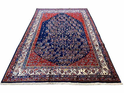 Qashqai exclusive Oriental rug with blue medallion, red border and fringes