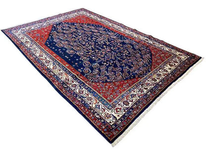 Qashqai exclusive Oriental rug spread diagonally: blue center, red inner border