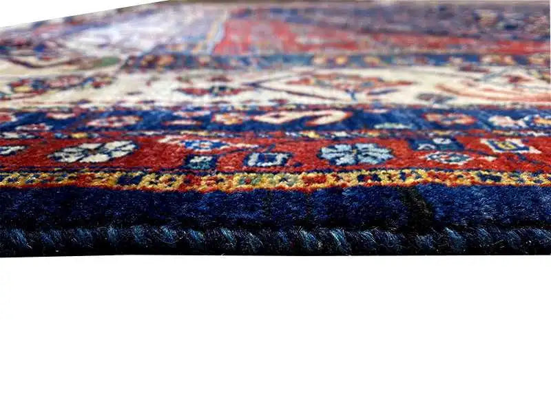 Qashqai exclusive Oriental rug close-up: dark blue border, multicolored patterns, fringe