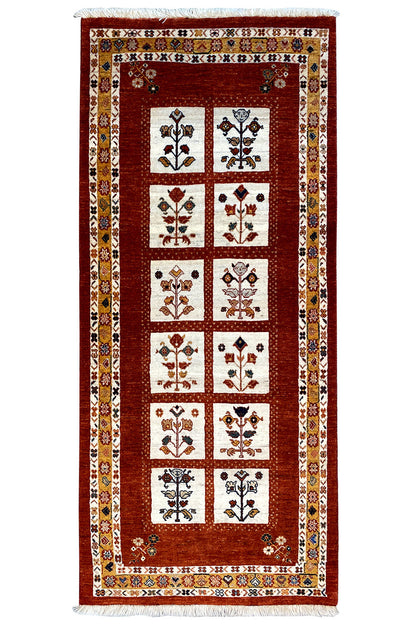 Oriental rug with a red square grid and multicolored ornaments in the fields.