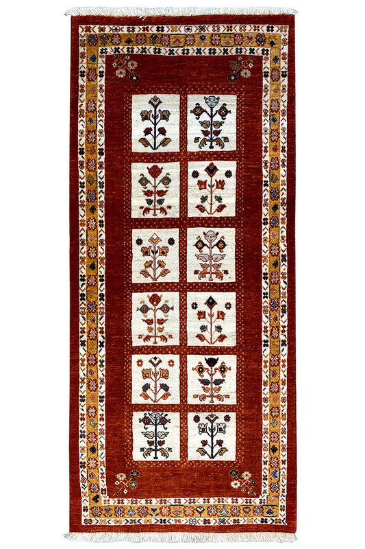 Oriental rug with a red square grid and multicolored ornaments in the fields.