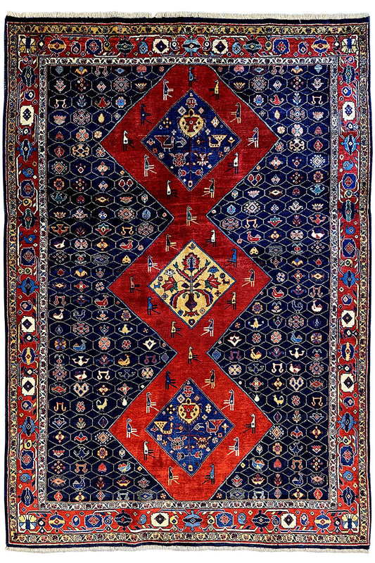 Blue-red Oriental rug with a large red medallion and surrounding border