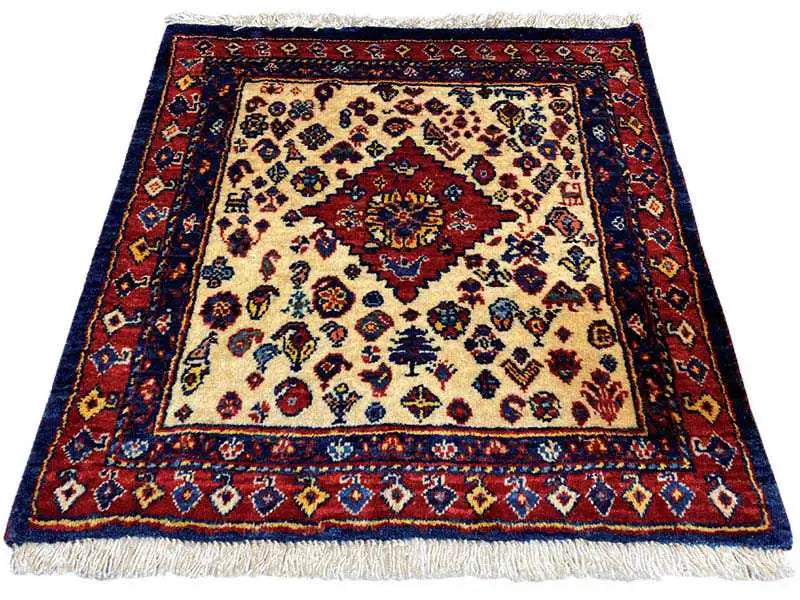 Square oriental rug with a red medallion, cream-colored background, and blue border