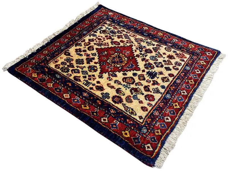 Square Oriental rug with a cream-colored central area, red border, and fringes