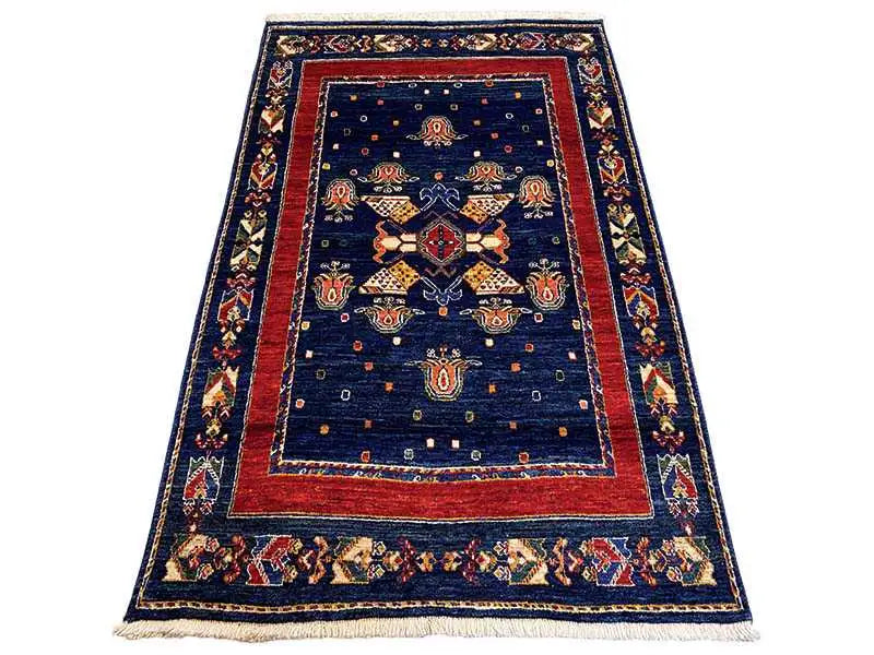 Rug: dark blue with a red border and central medallion ornaments