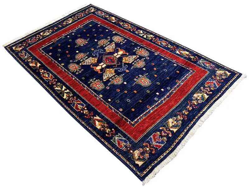 Rug: dark blue, red central frame, geometric edges and border