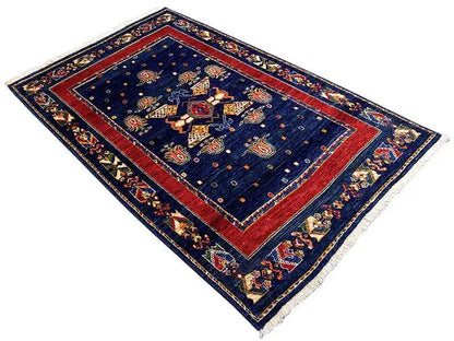 Rug: dark blue, red central frame, geometric edges and border