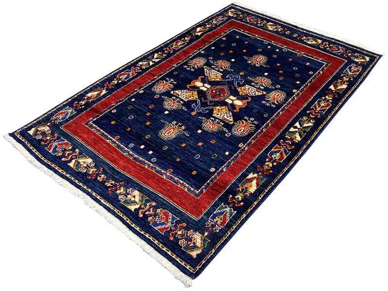Rug: dark blue with a red inner border, ornamental center, frayed edges