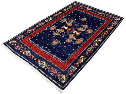 Rug: dark blue with a red inner border, ornamental center, frayed edges