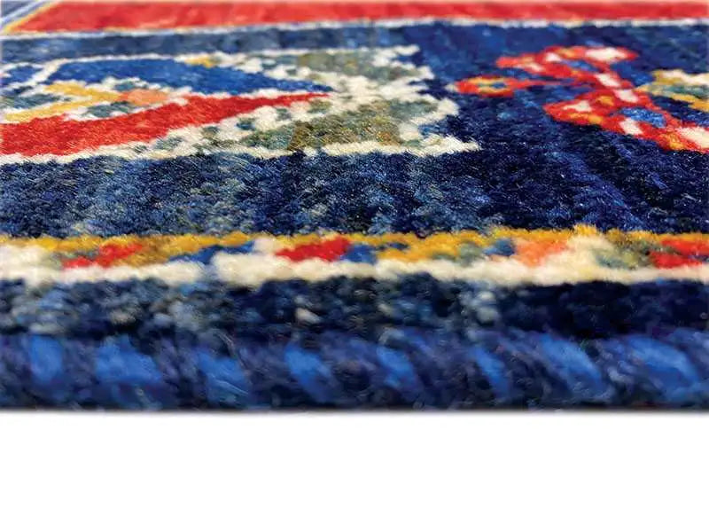 Carpet pile in detail: blue, red and beige with a multicolored border