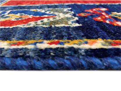 Carpet pile in detail: blue, red and beige with a multicolored border