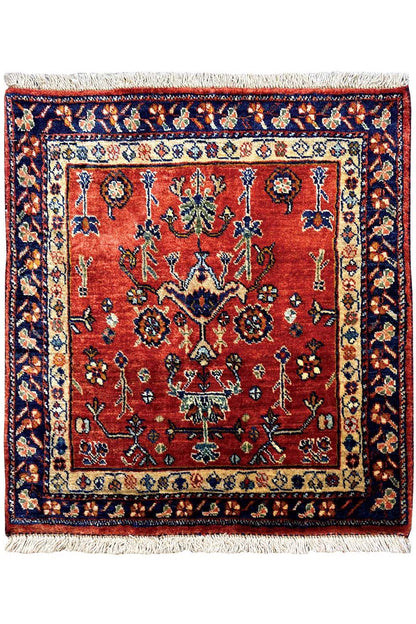 Square rug with a red central medallion, blue border, and fringe
