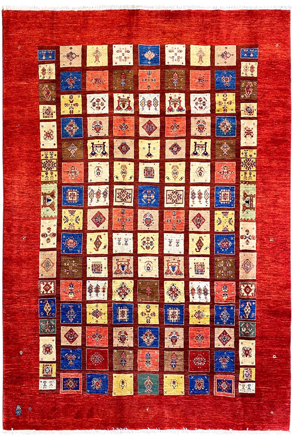 Rug with a red border and a large geometric patchwork pattern in many colors