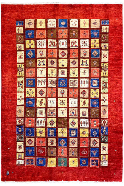 Rug with a red border and a large geometric patchwork pattern in many colors