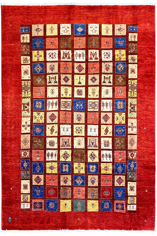 Rug with a red border and a large geometric patchwork pattern in many colors