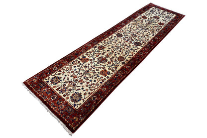 Oriental rug laid flat with a red border and beige ornamental field