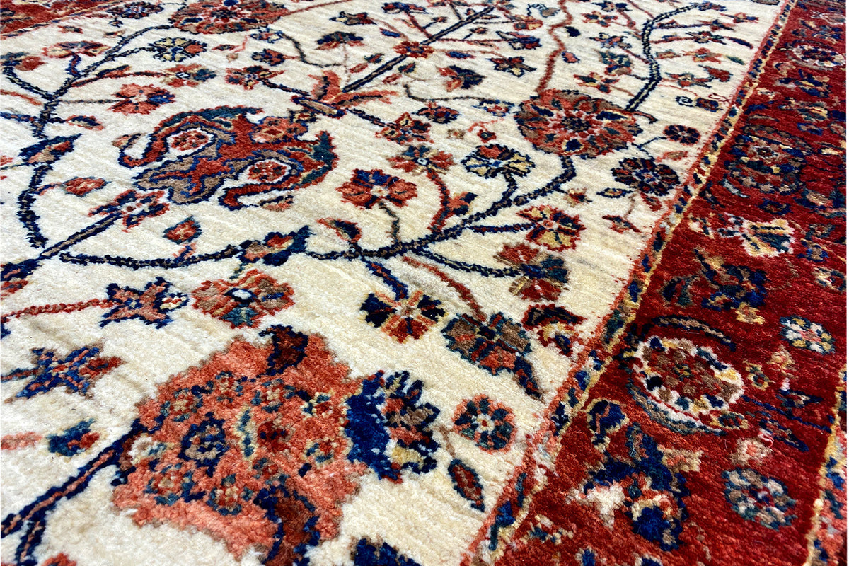 Close-up: beige ornamental panel with blue and red accents around the edge